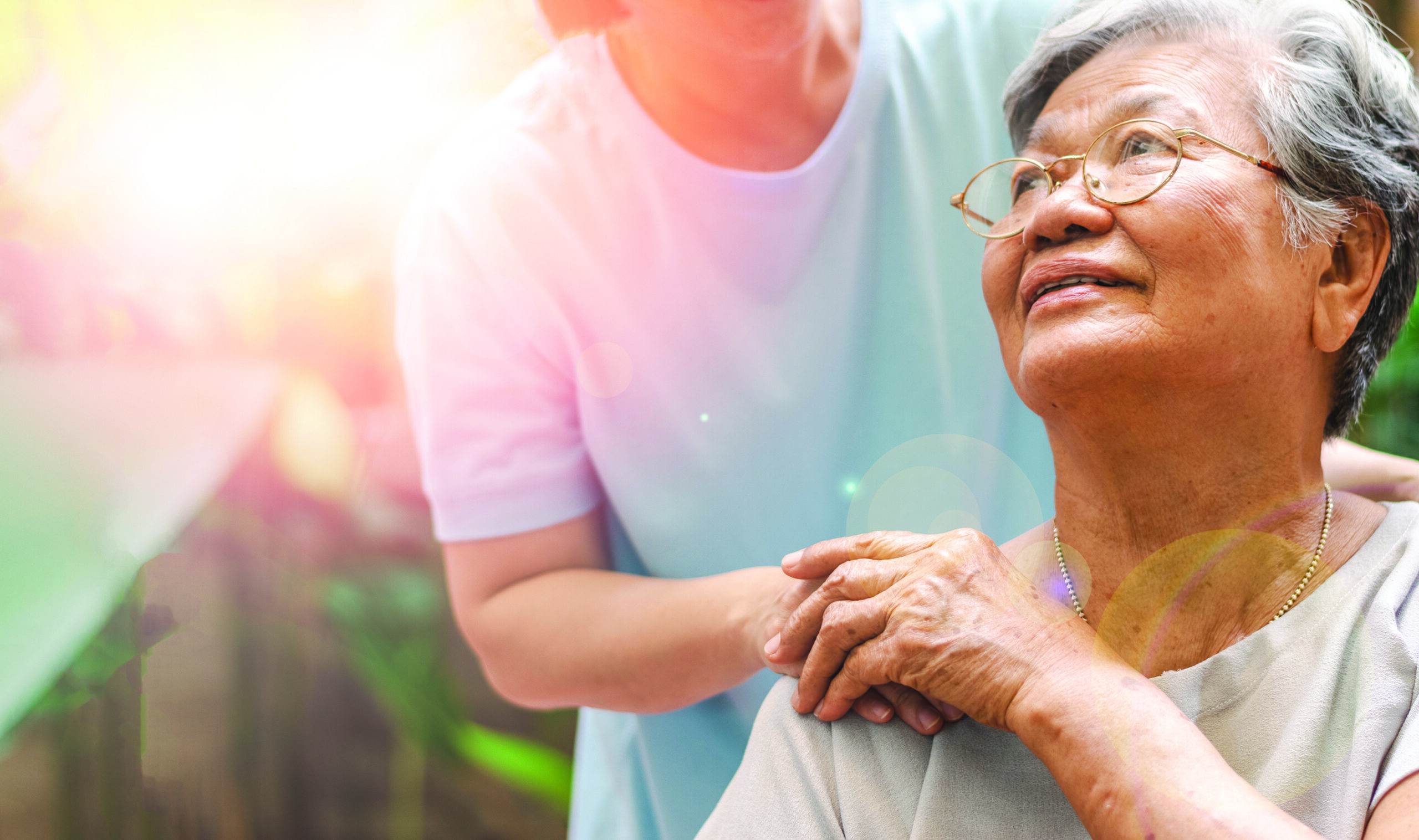 A hospice caregiver gently comforting an elderly woman.