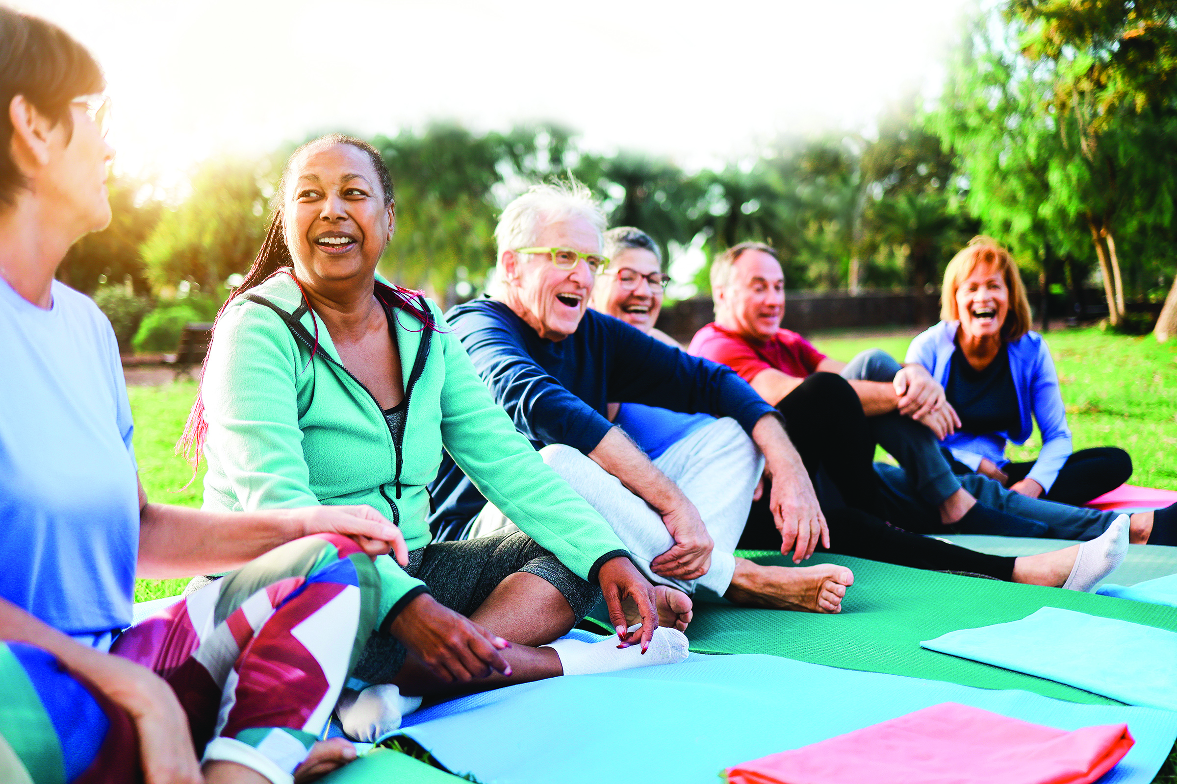 Group of older adults participating in a fitness class at a senior center, enjoying social connection and wellness activities.